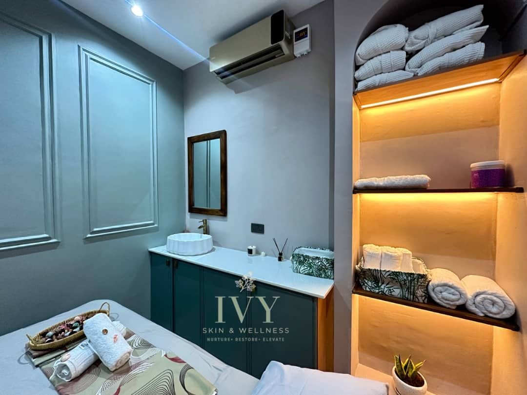 Massage room at IVY Skin & Wellness with warm shelf lighting